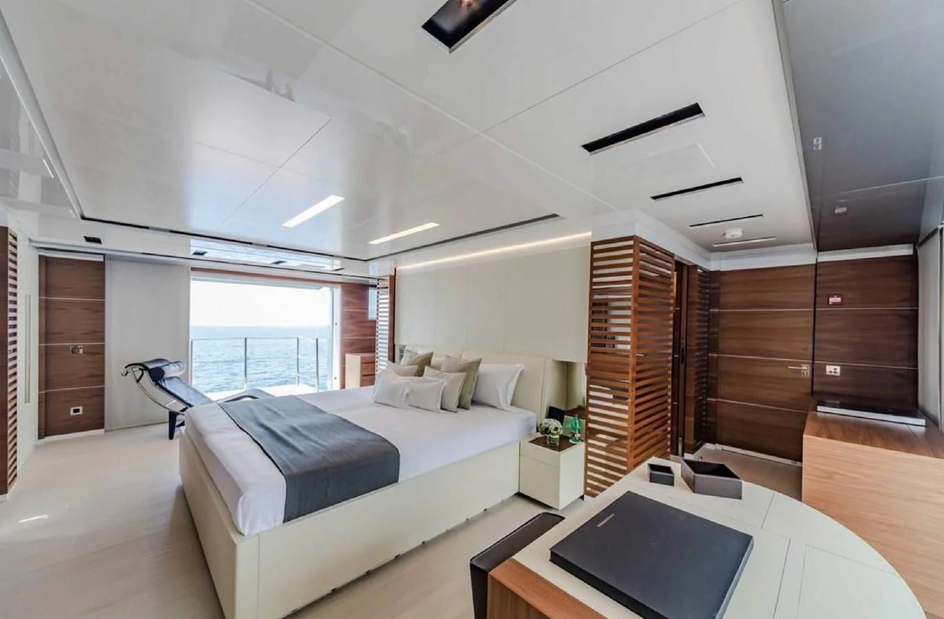 a room with a bed and a desk aboard LADY A Yacht for Sale