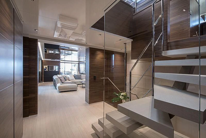 a room with a staircase and a couch aboard LADY A Yacht for Sale