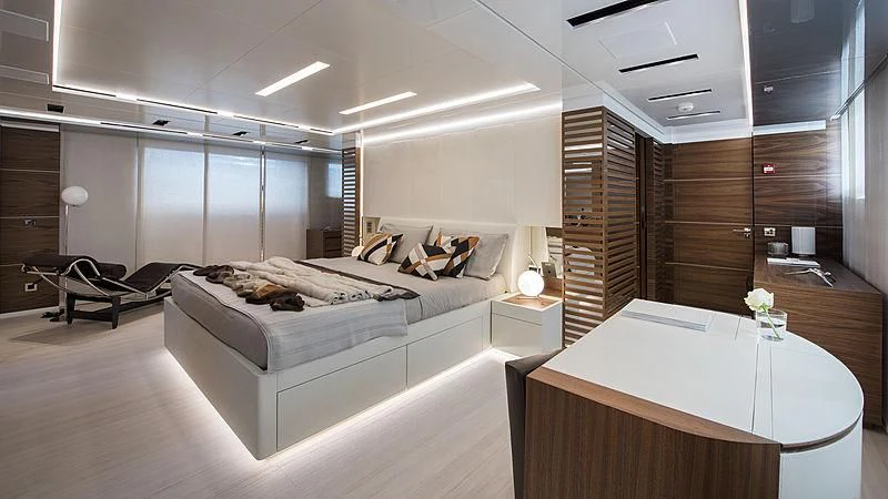 a room with a bed and a desk aboard LADY A Yacht for Sale
