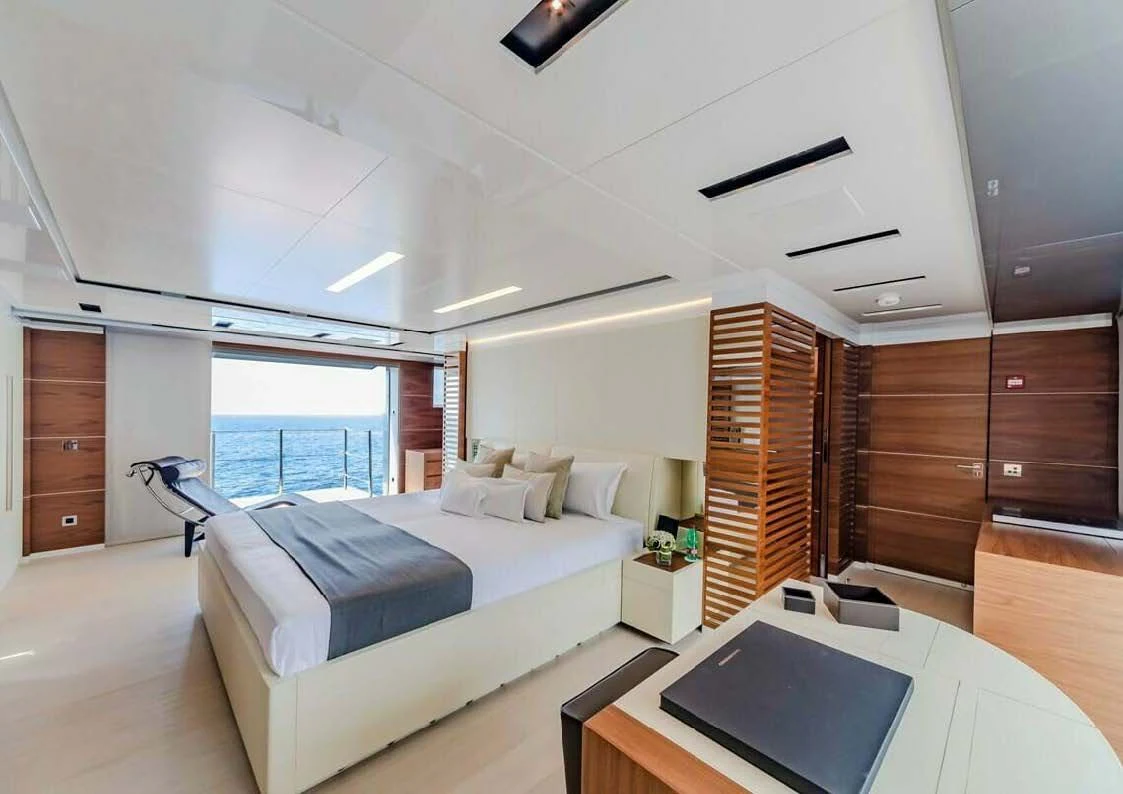 a room with a bed and a desk aboard LADY A Yacht for Sale