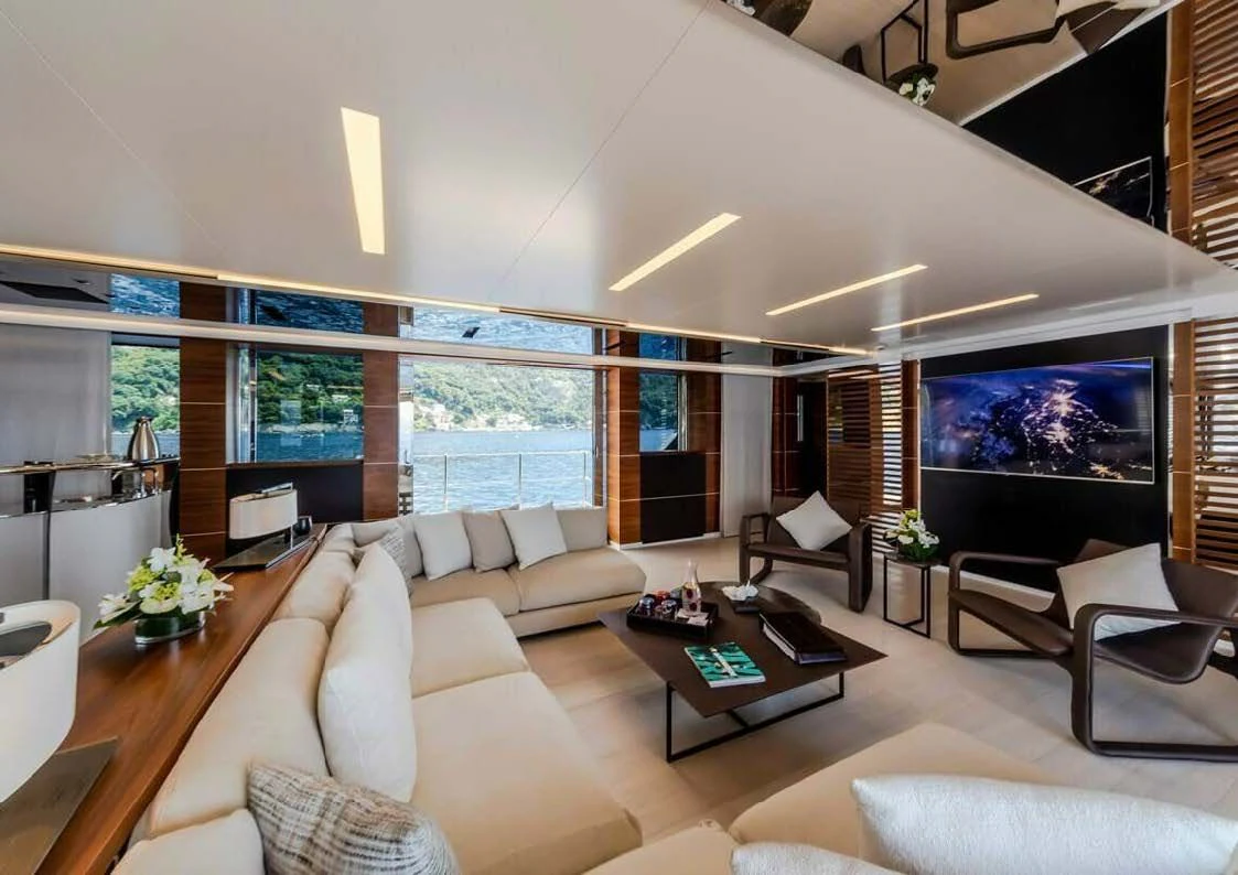 a living room with a large screen aboard LADY A Yacht for Sale