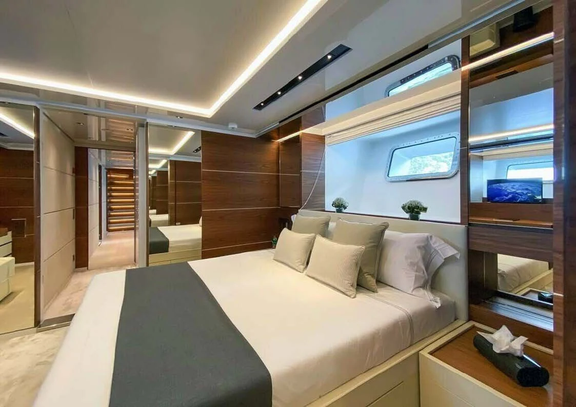 a room with a bed and a window aboard LADY A Yacht for Sale
