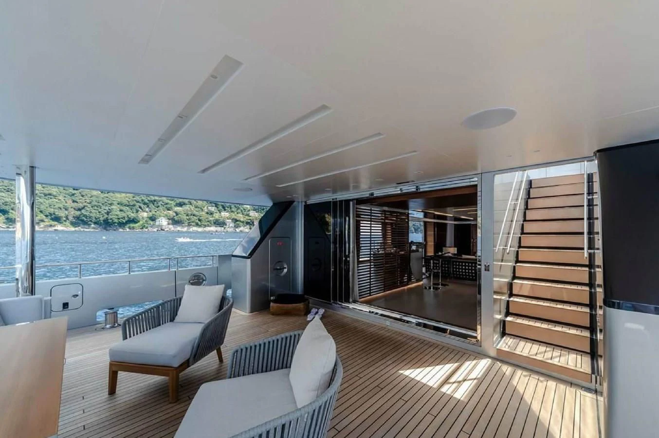 a room with a view of the ocean and a deck aboard LADY A Yacht for Sale