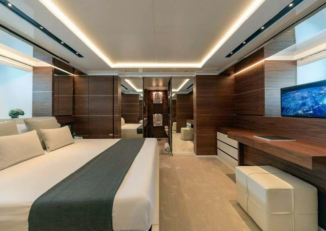 a room with a bed and a desk aboard LADY A Yacht for Sale