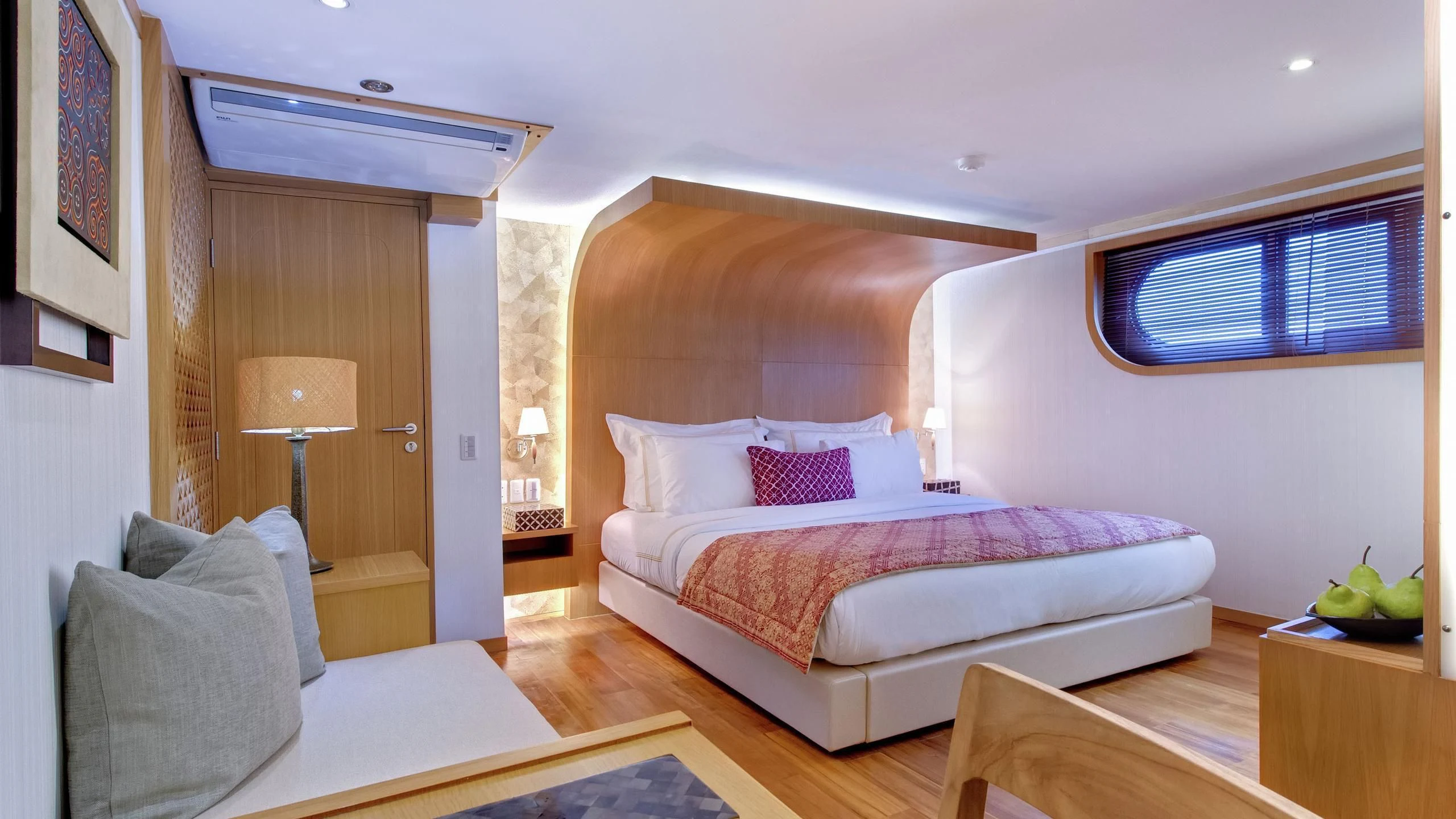 a bedroom with a bed and a lamp aboard SALILA Yacht for Sale