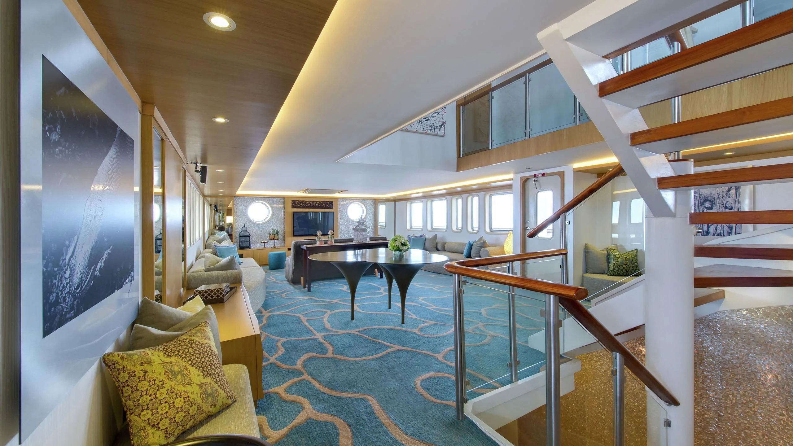 a room with a table and couch aboard SALILA Yacht for Sale