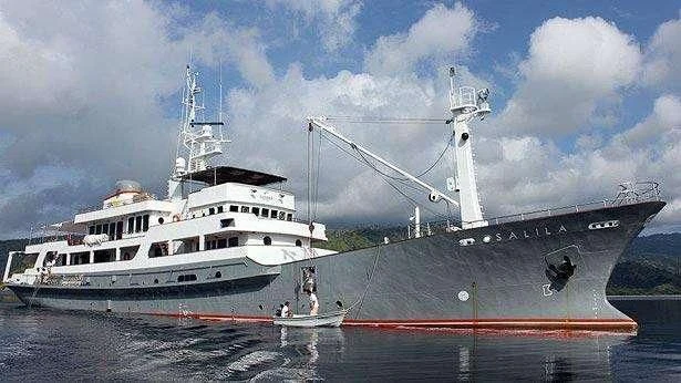 a large boat next to a smaller boat in the water aboard SALILA Yacht for Sale