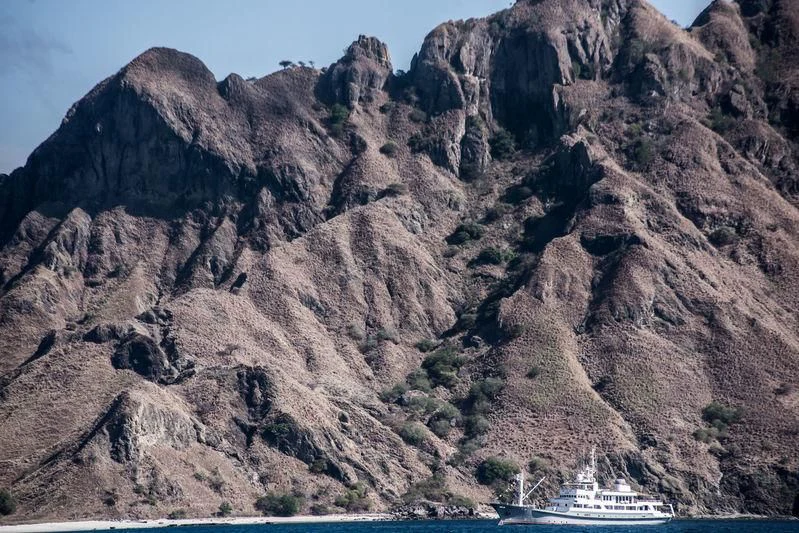 a boat on a river in a valley between mountains aboard SALILA Yacht for Sale