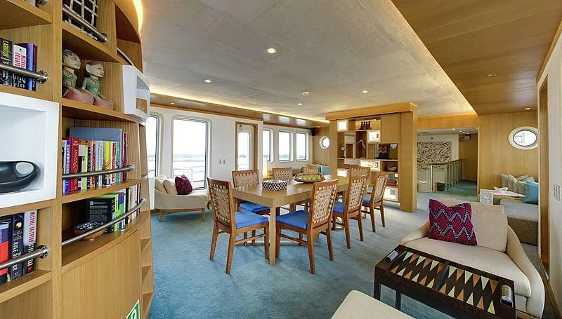 a living room with a table and chairs aboard SALILA Yacht for Sale