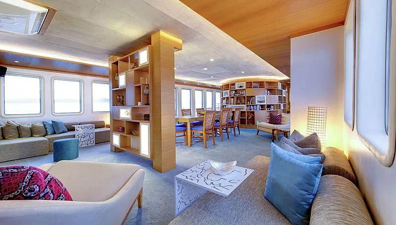 a living room with a couch and a table aboard SALILA Yacht for Sale