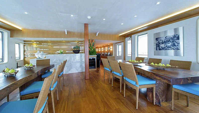 a large room with tables and chairs aboard SALILA Yacht for Sale