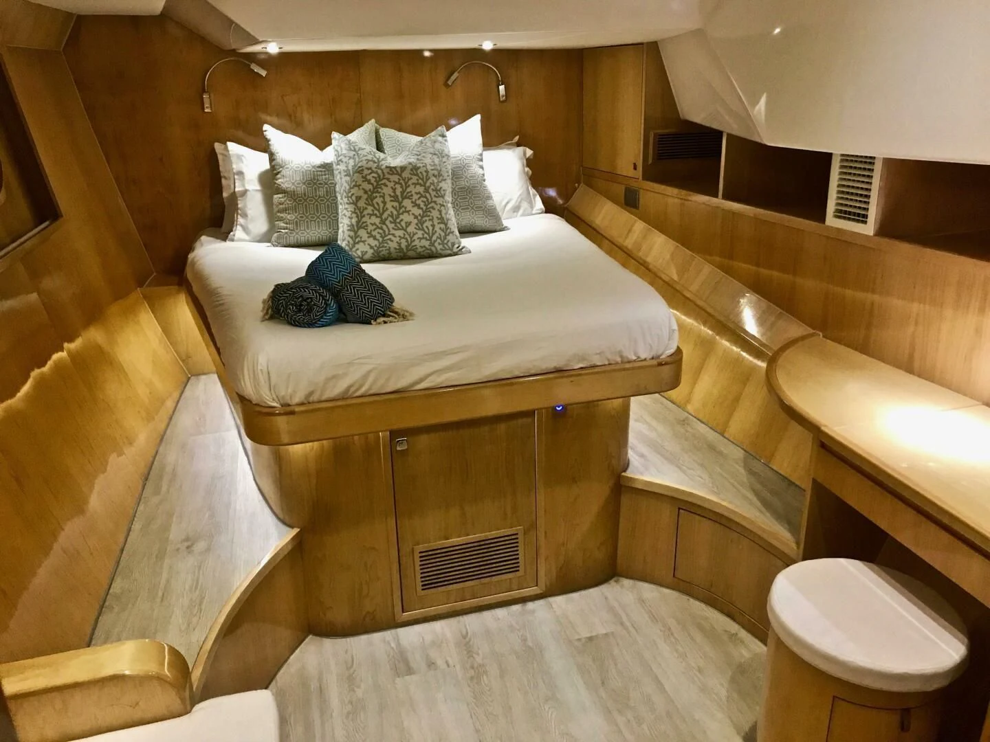 a bed with a white sheet and pillows on it aboard LAYSAN Yacht for Sale