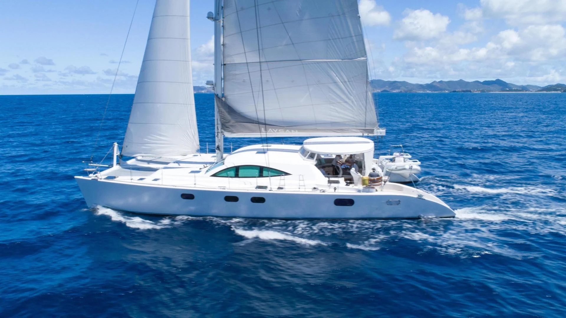 a white boat on the water aboard LAYSAN Yacht for Sale
