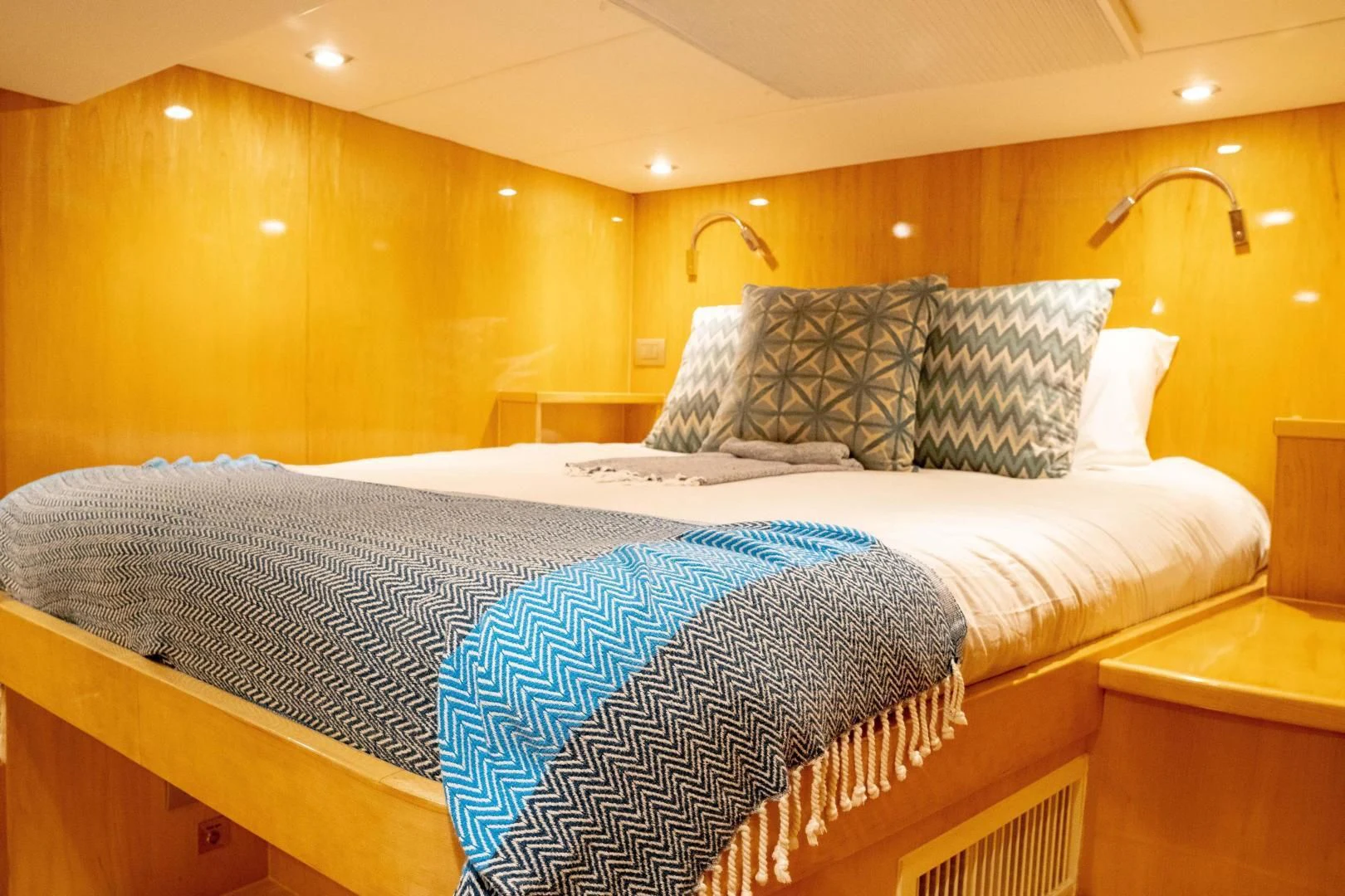 a bed with white sheets aboard LAYSAN Yacht for Sale