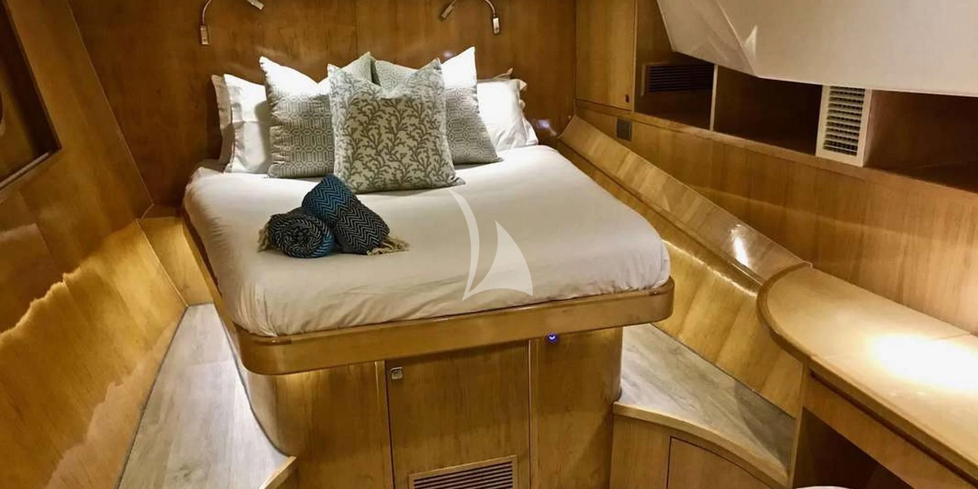 a bed with white sheets and pillows aboard LAYSAN Yacht for Sale