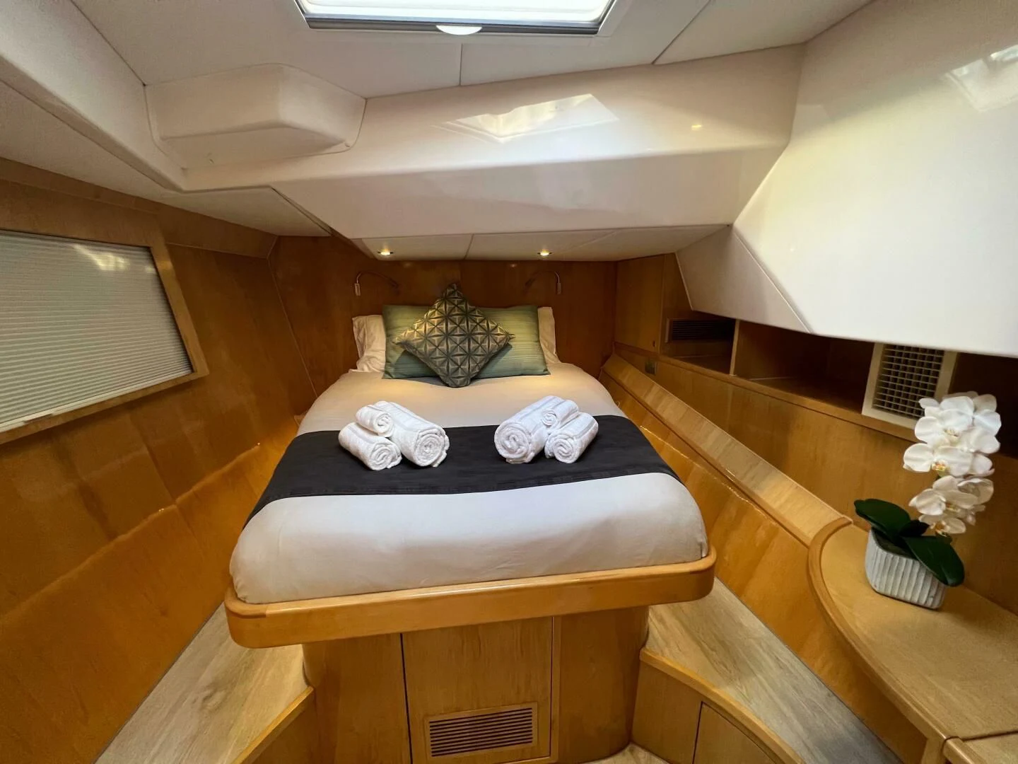 a bed with a couple of pillows on it aboard LAYSAN Yacht for Sale