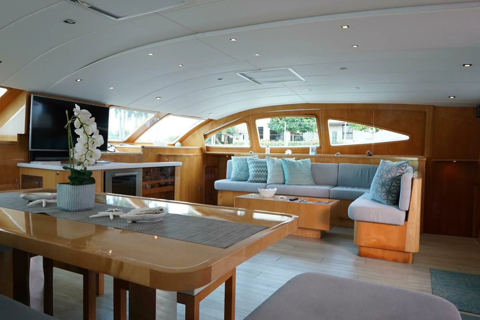 a living room with a table and couches aboard LAYSAN Yacht for Sale