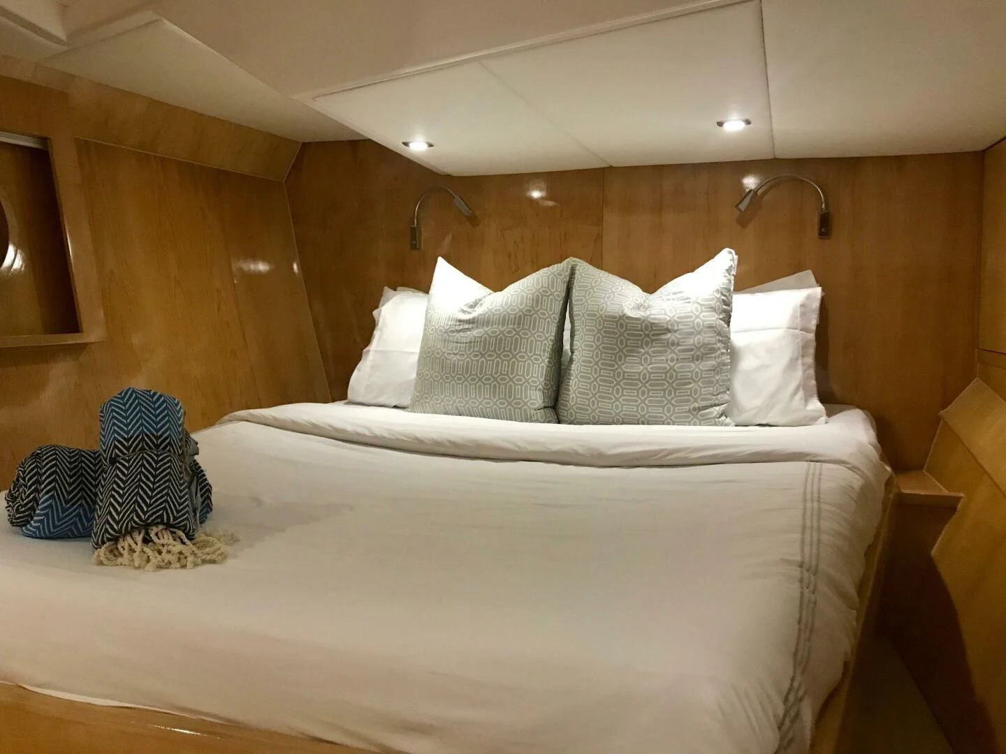 a bed with white sheets aboard LAYSAN Yacht for Sale