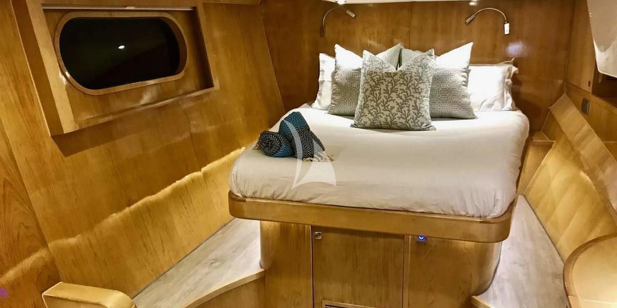 a bed with pillows and blankets aboard LAYSAN Yacht for Sale