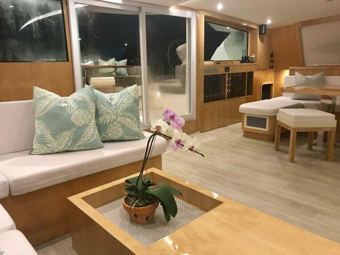 a living room with a plant in a pot on a table aboard LAYSAN Yacht for Sale