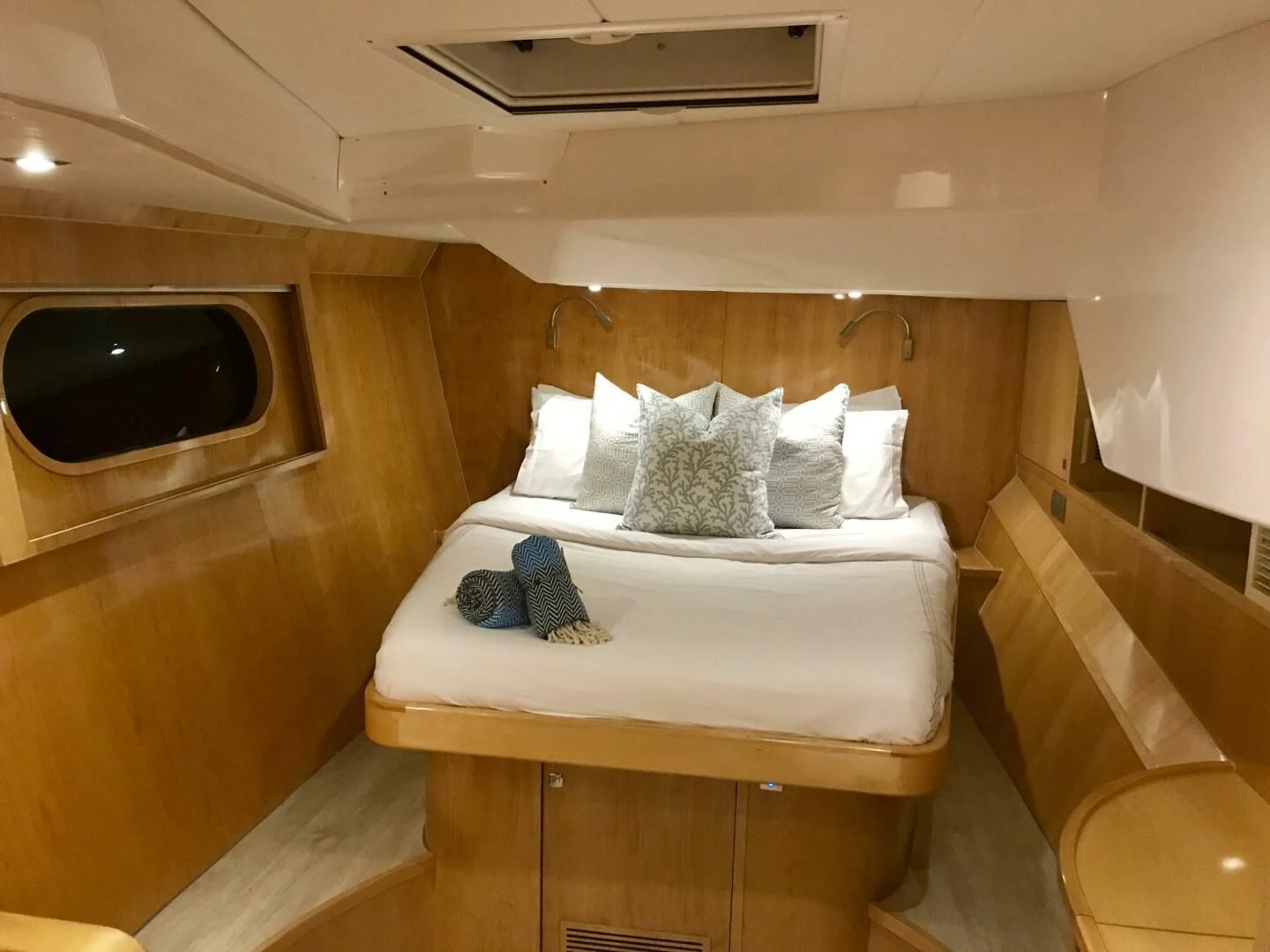 a bed with white sheets and pillows aboard LAYSAN Yacht for Sale