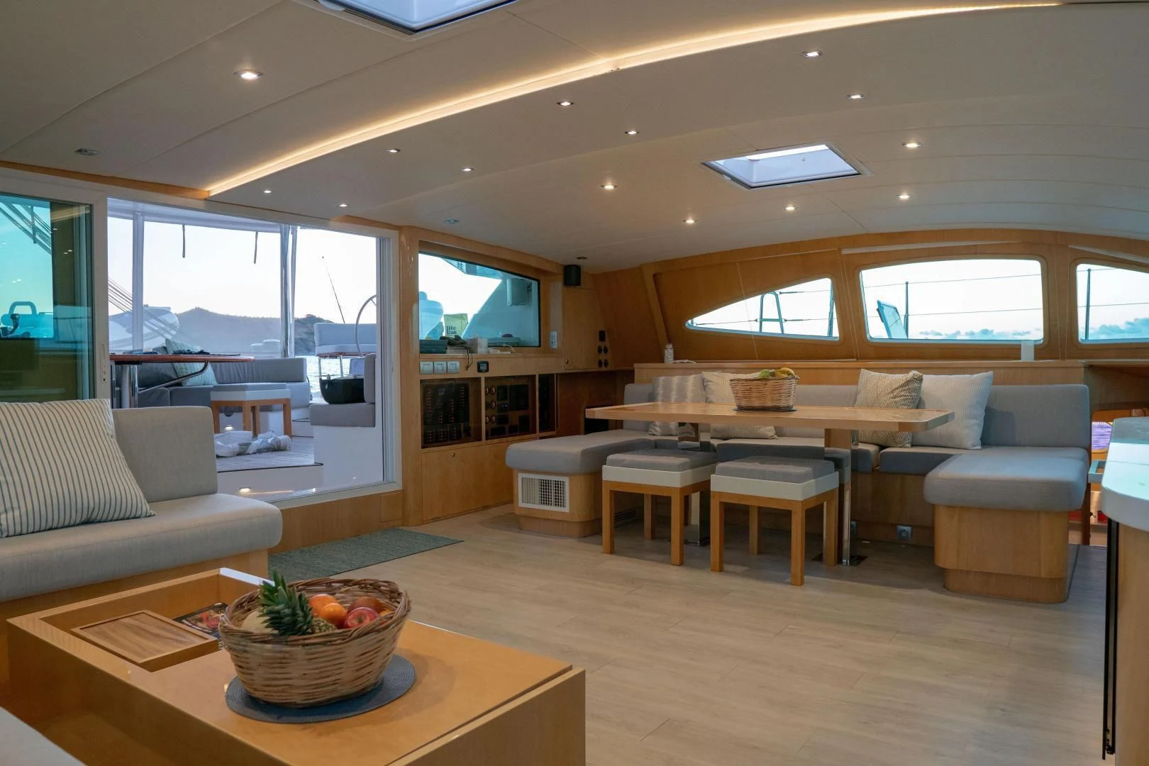 a living room with a table and couches aboard LAYSAN Yacht for Sale