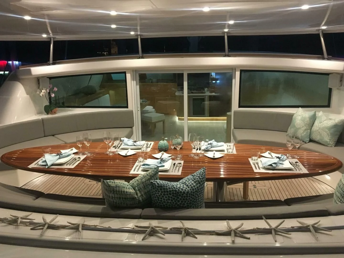 a table with chairs and a couch aboard LAYSAN Yacht for Sale