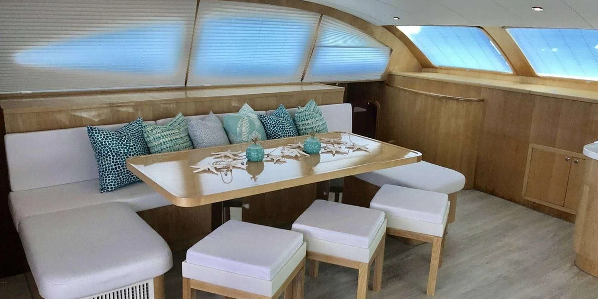 a room with a table and chairs aboard LAYSAN Yacht for Sale