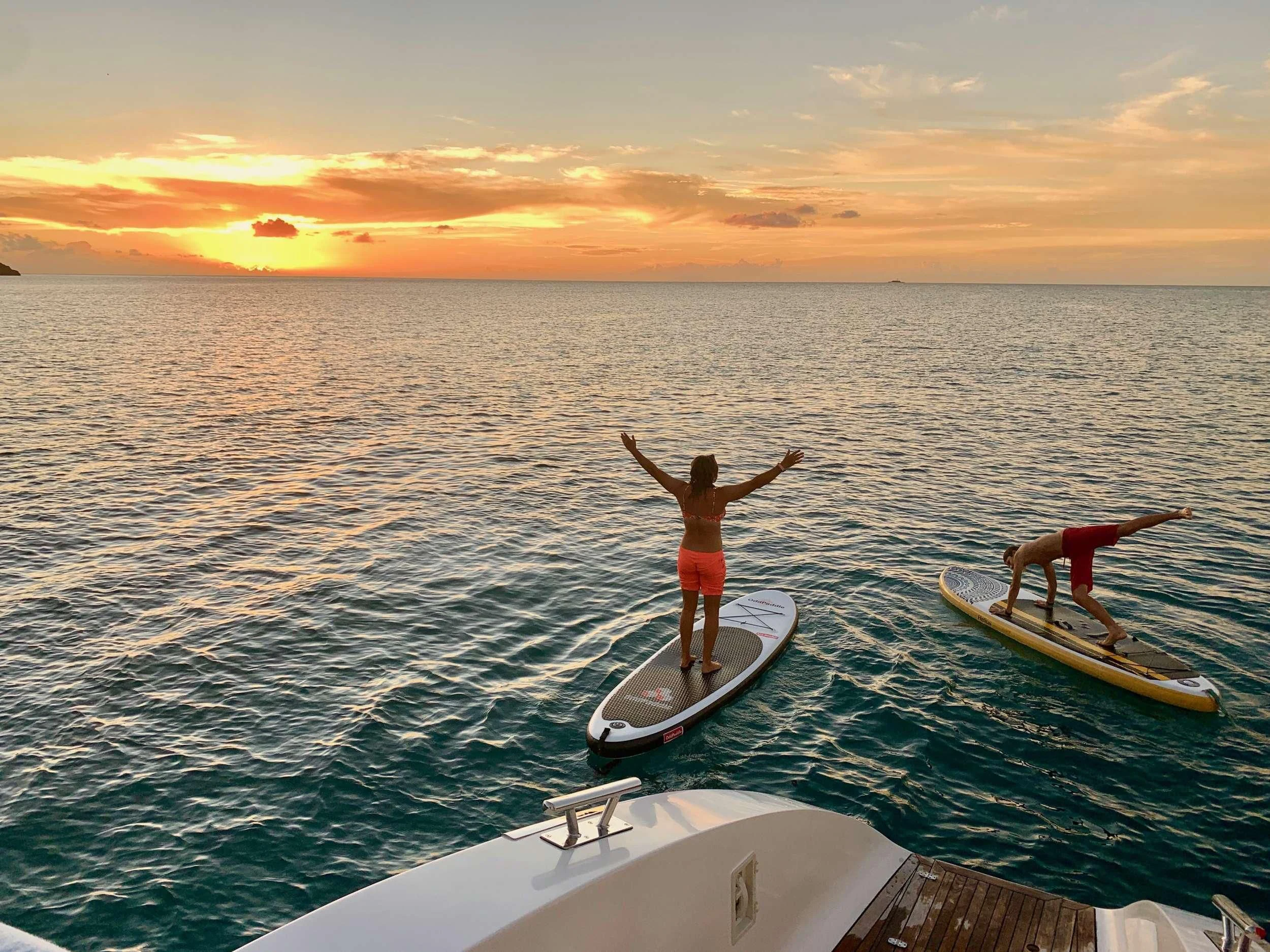 a couple of people on surfboards in the water aboard LAYSAN Yacht for Sale