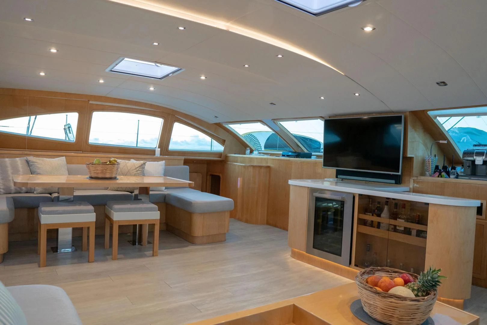 a room with a tv and couches aboard LAYSAN Yacht for Sale