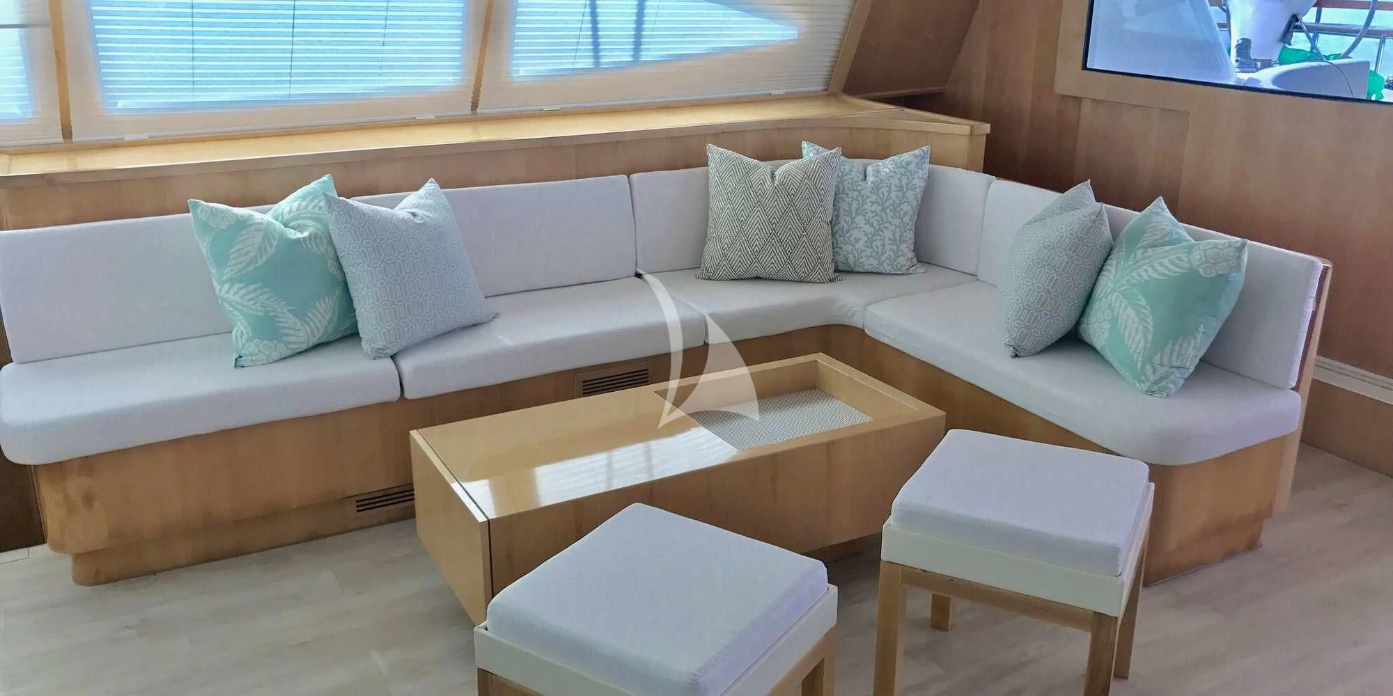a couch with pillows and a coffee table in front of it aboard LAYSAN Yacht for Sale