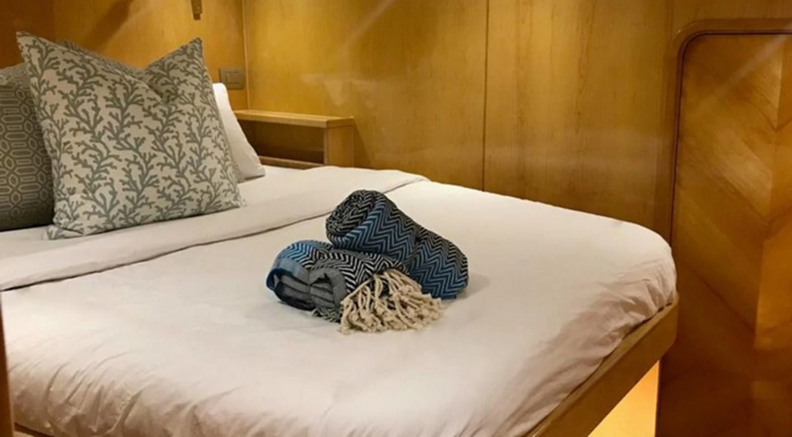 a pair of socks on a bed aboard LAYSAN Yacht for Sale