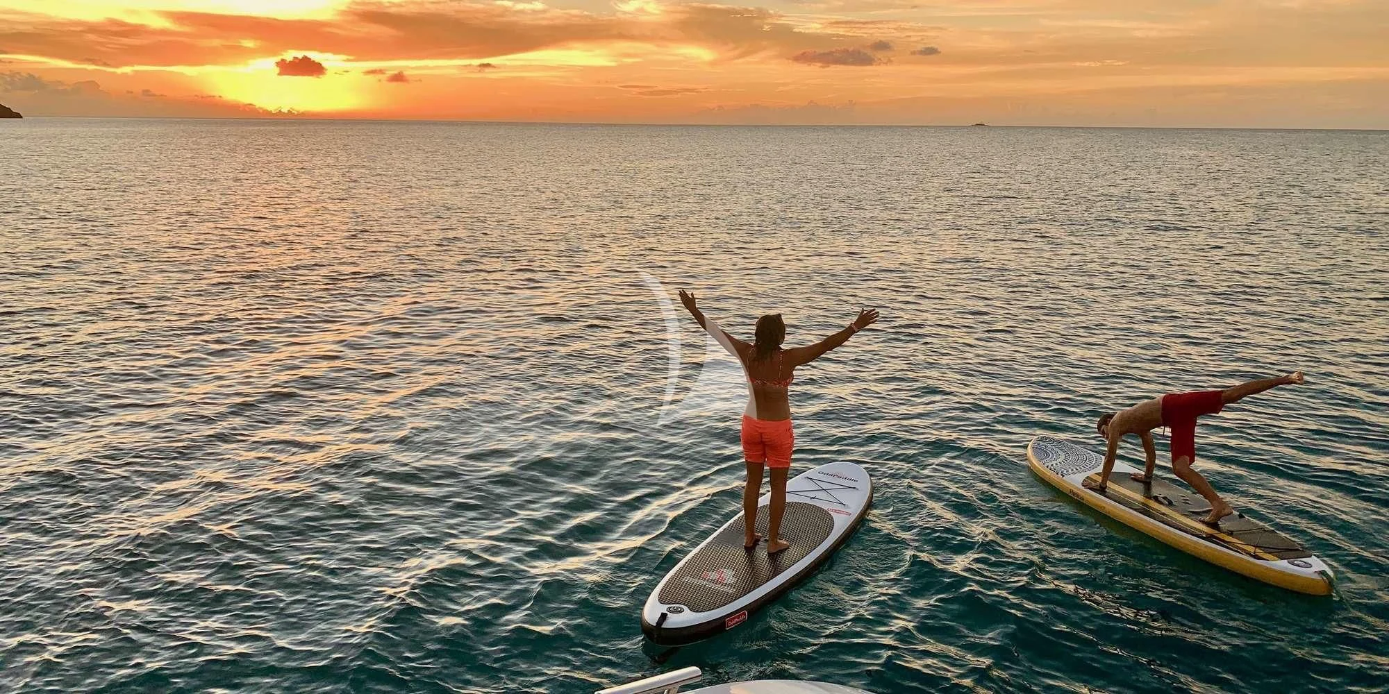a person on a surfboard in the ocean aboard LAYSAN Yacht for Sale