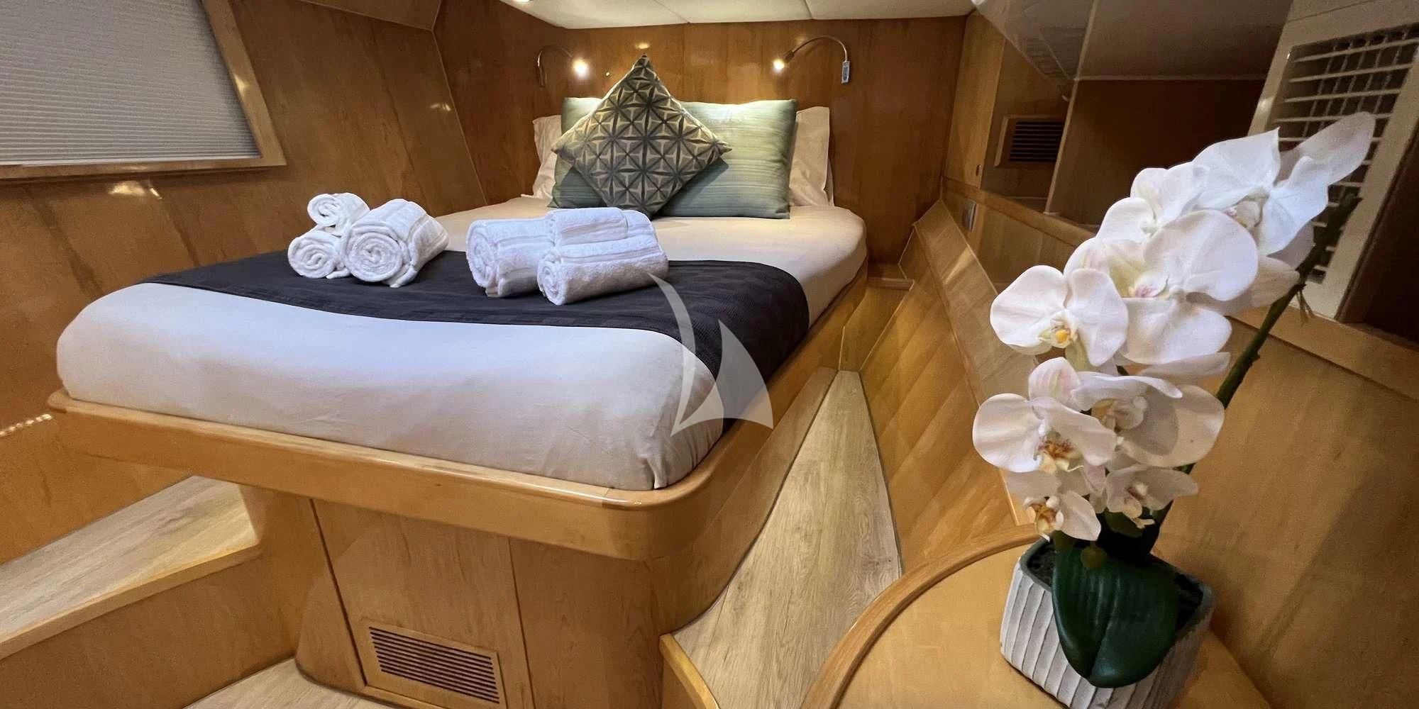 a bed with white flowers aboard LAYSAN Yacht for Sale