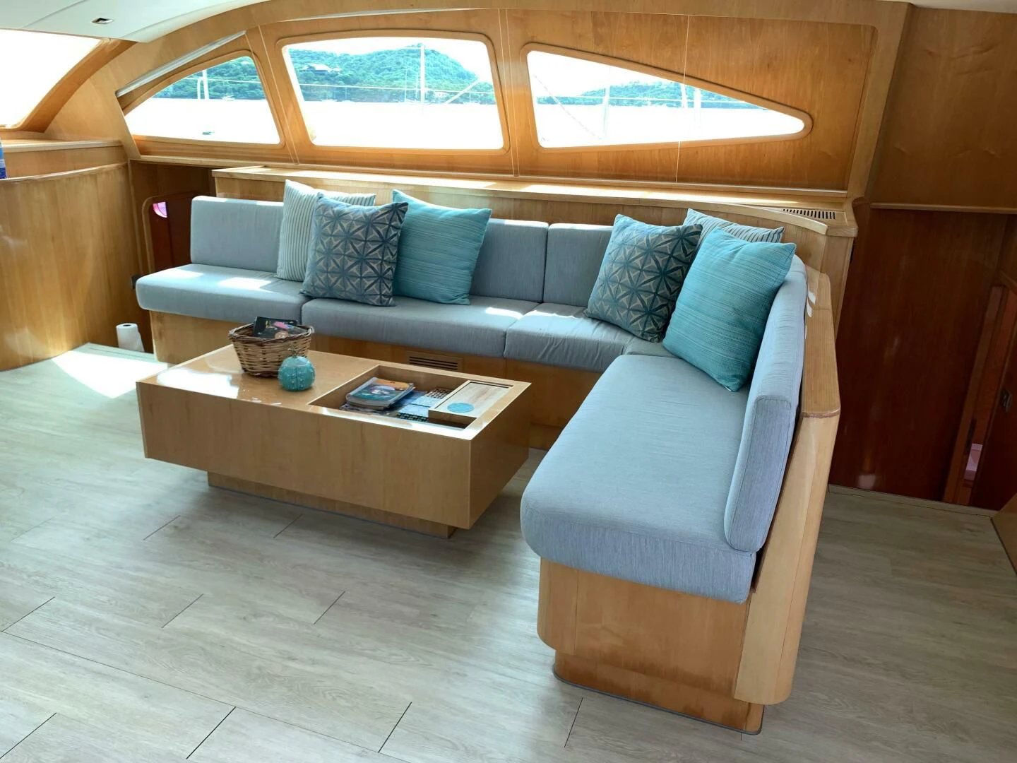a couch and a table in a room aboard LAYSAN Yacht for Sale