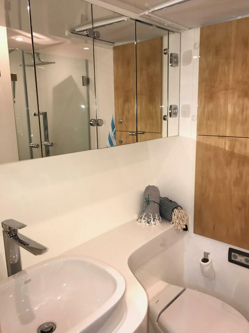 a bathroom with a large mirror aboard LAYSAN Yacht for Sale