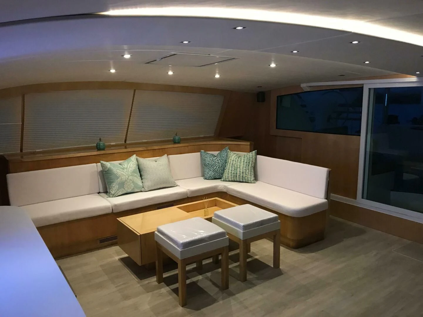 a couch with a table in a room with a window aboard LAYSAN Yacht for Sale