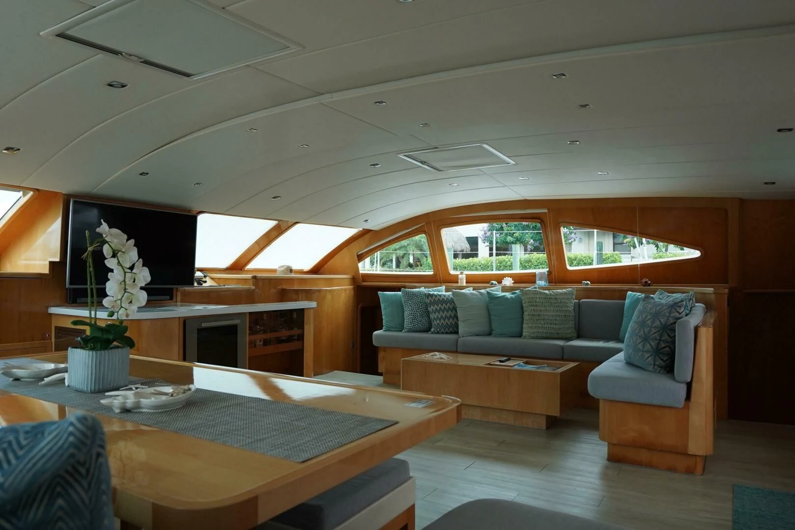 a living room with a couch and a table aboard LAYSAN Yacht for Sale