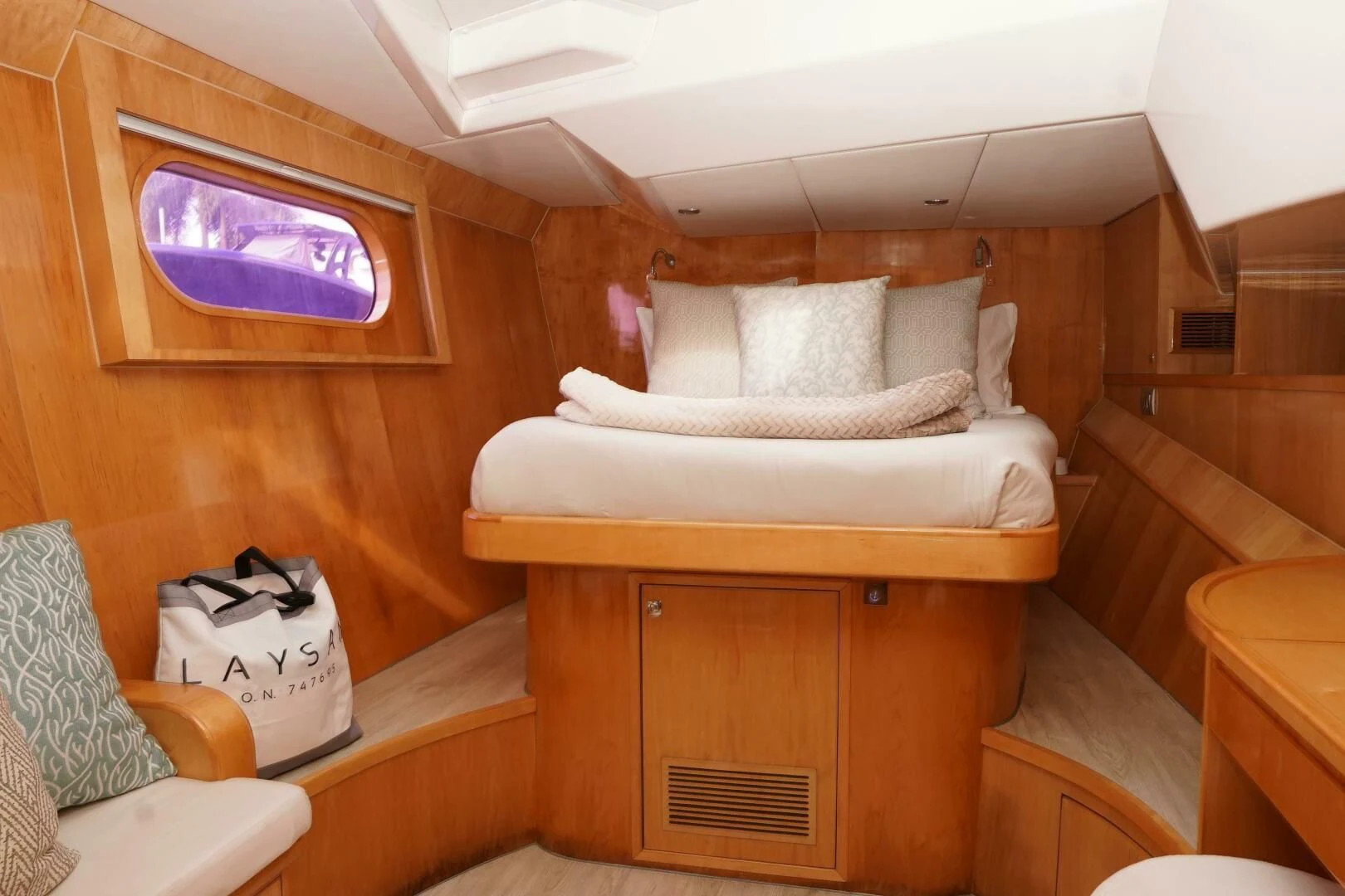 a room with a bed and a dresser aboard LAYSAN Yacht for Sale