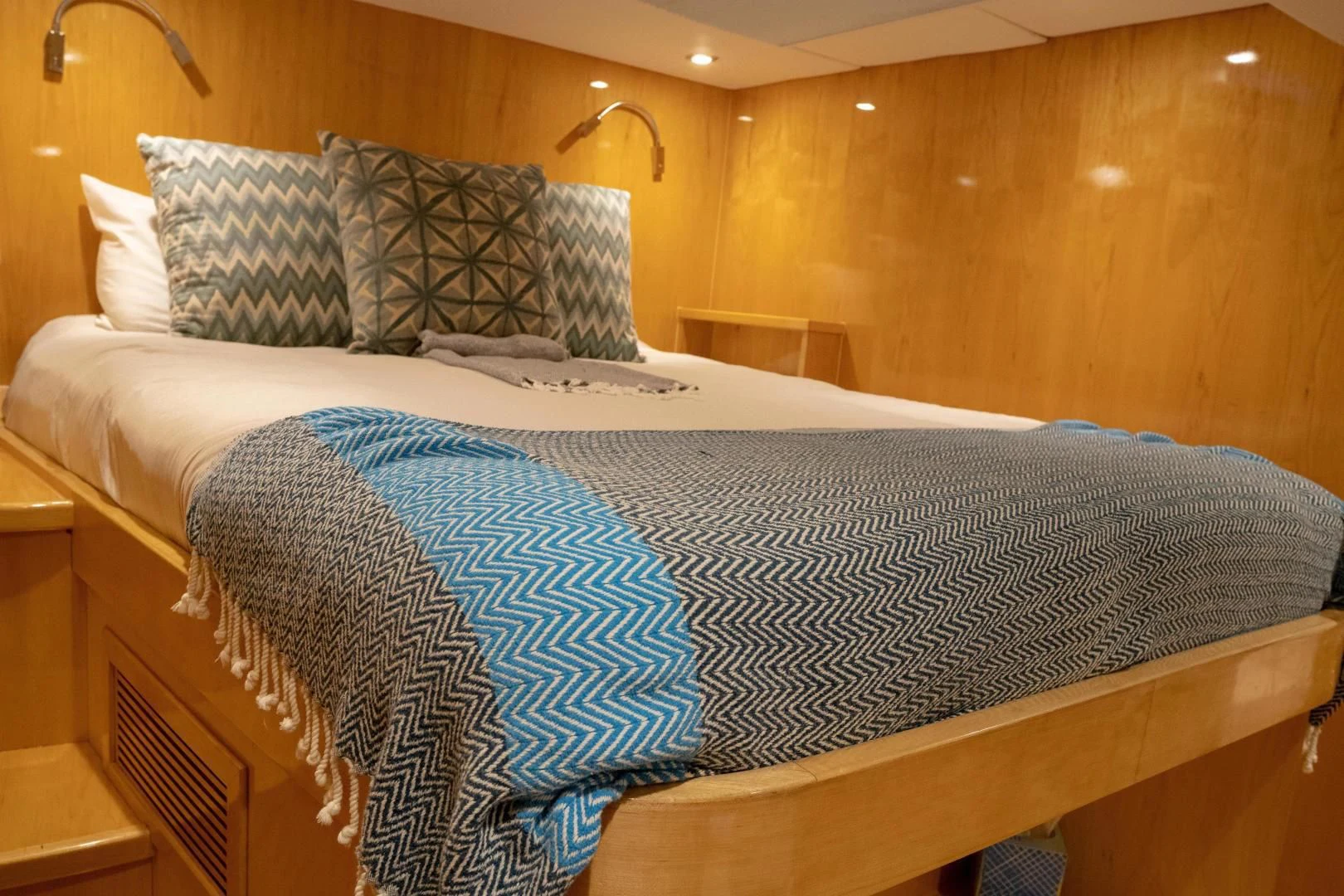 a bed with white sheets aboard LAYSAN Yacht for Sale