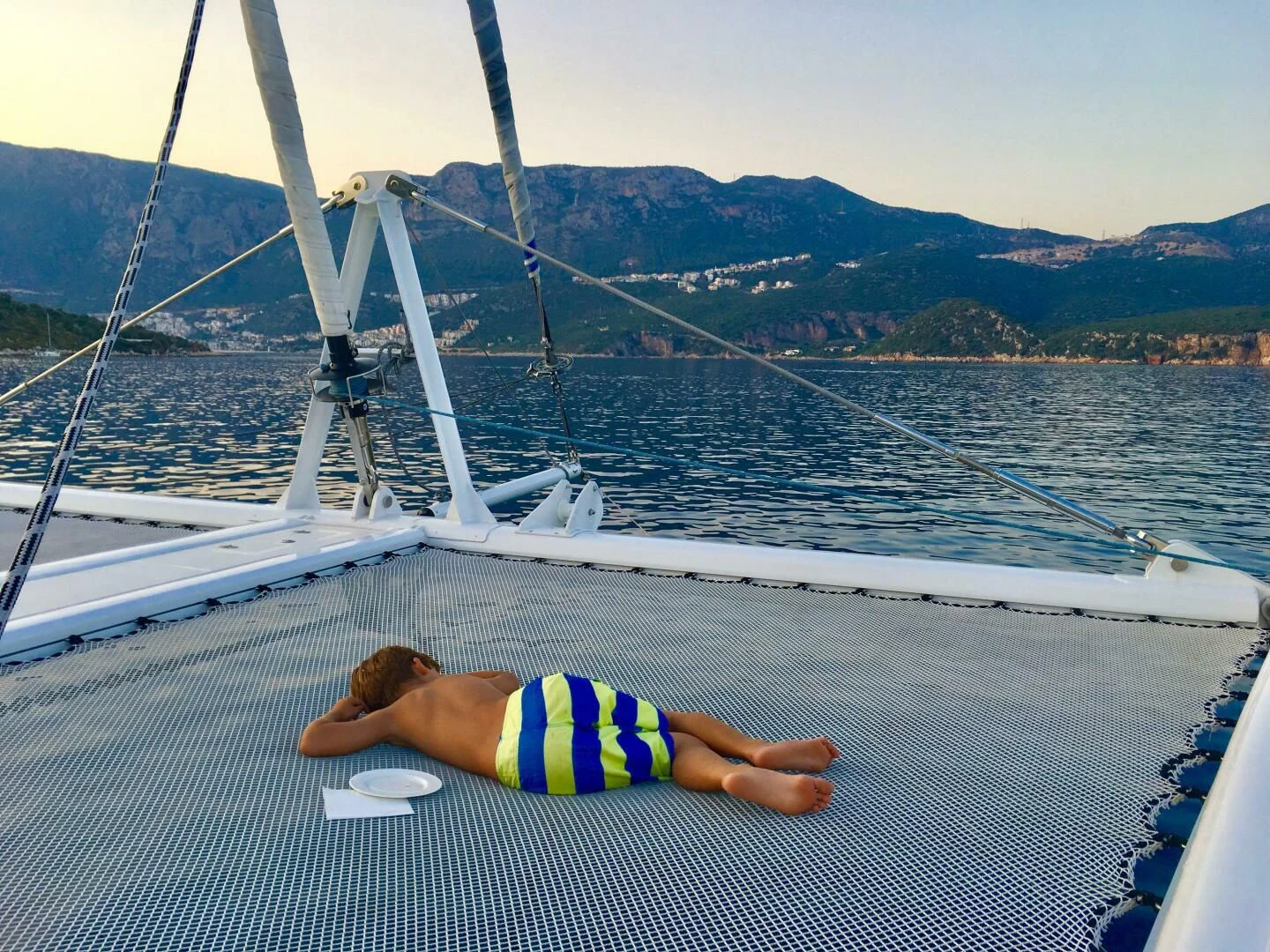 a child lying on a boat aboard LAYSAN Yacht for Sale