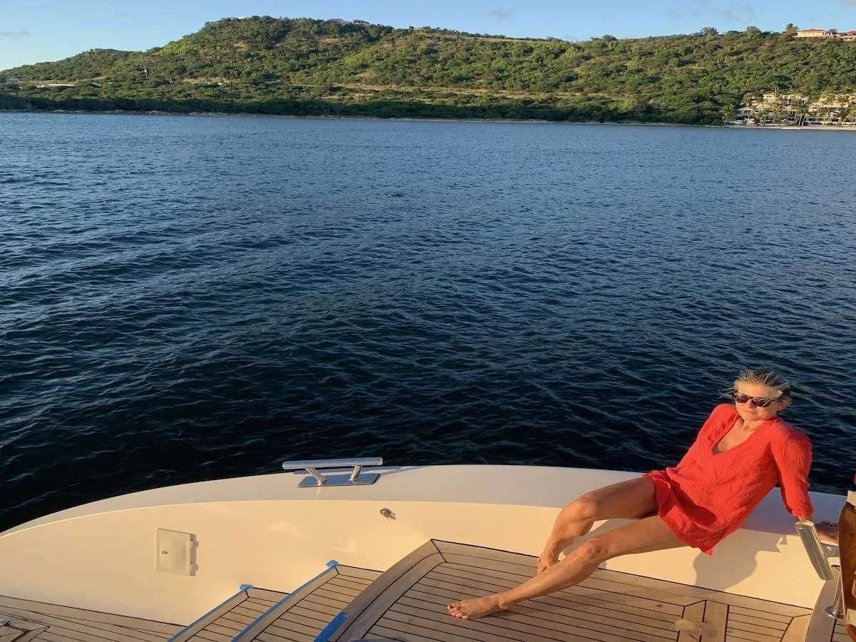 a man sitting on a boat aboard LAYSAN Yacht for Sale