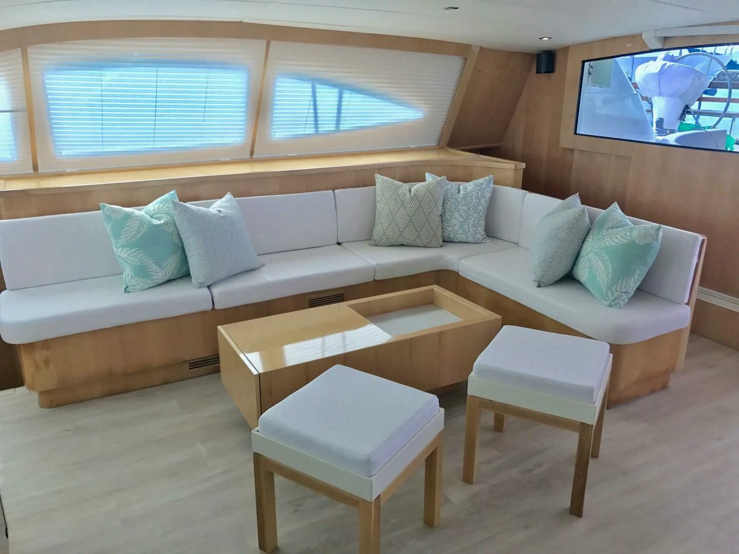 a couch with pillows and a table aboard LAYSAN Yacht for Sale