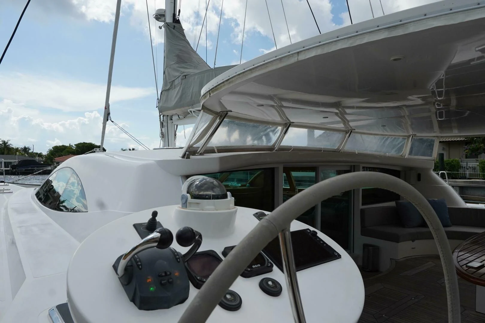 a white boat with a white sail aboard LAYSAN Yacht for Sale