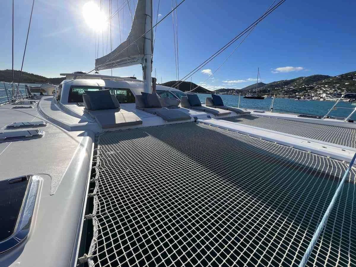 a deck with a view of the water and the land below aboard LAYSAN Yacht for Sale