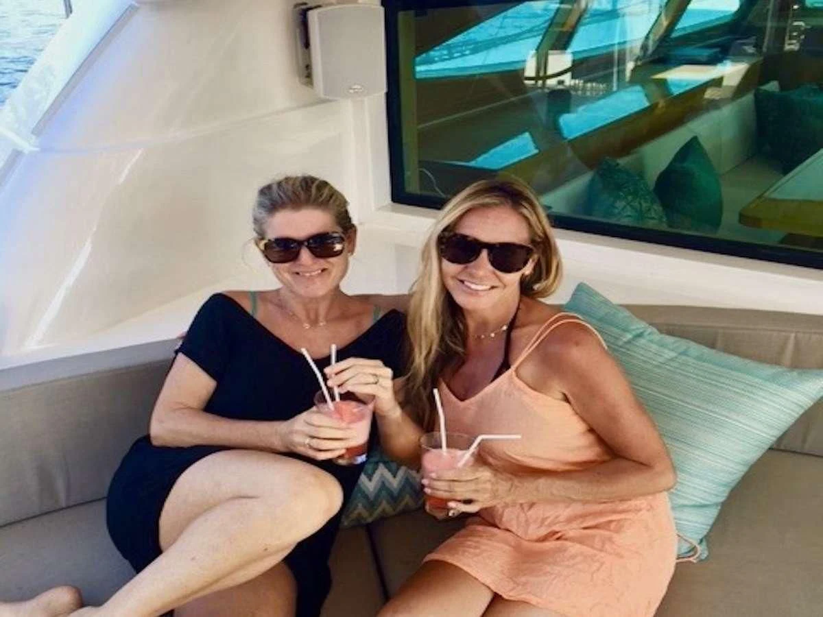 two women sitting on a couch aboard LAYSAN Yacht for Sale