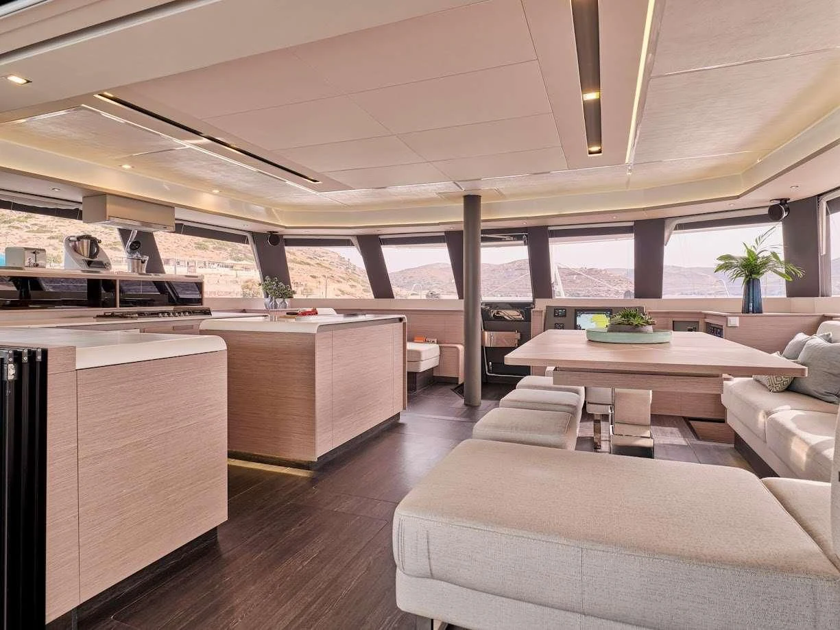 a room with a table and couches aboard DOLLY Yacht for Charter