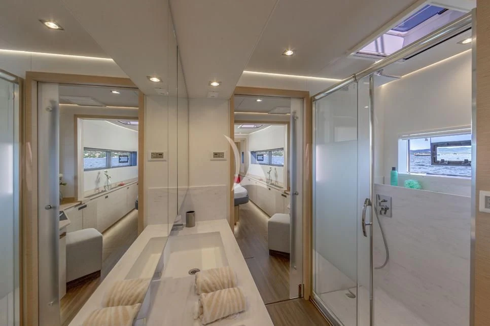 a long hallway with glass doors aboard DOLLY Yacht for Charter