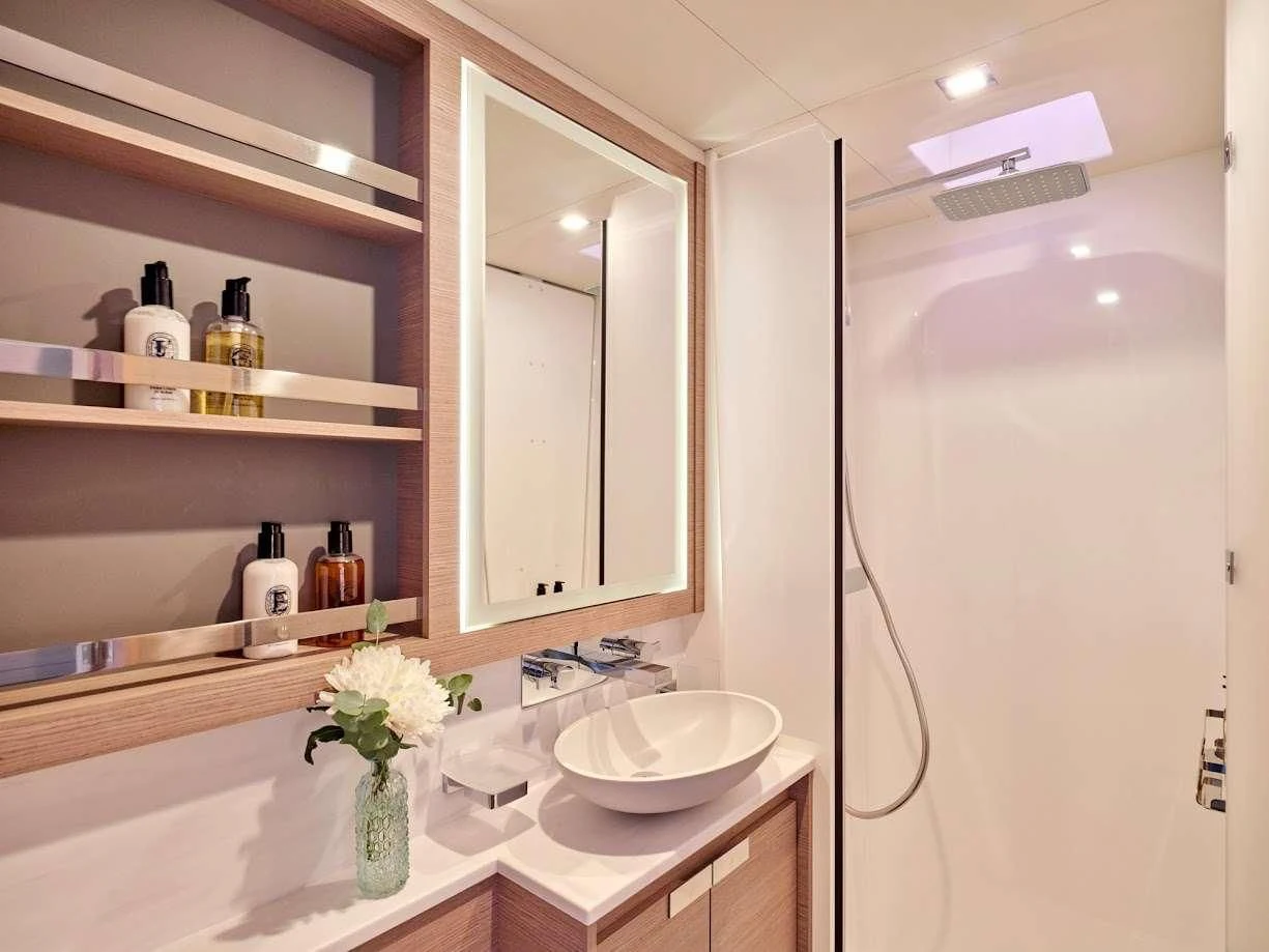 a bathroom with a sink and mirror aboard DOLLY Yacht for Charter
