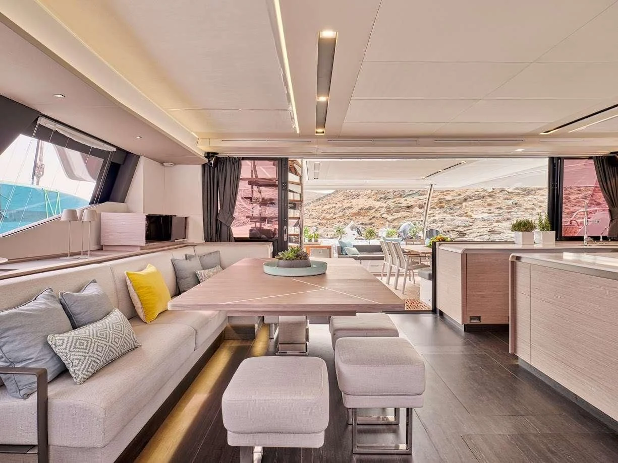 a living room with a large table and chairs aboard DOLLY Yacht for Charter